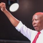 (FILES) Economic Freedom Fighters (EFF) leader Julius Malema gestures during their Tshela Thupa rally at the New Peter Mokaba Stadium in Polokwane on May 25, 2024 ahead of the country's upcoming national and provincial elections on May 29, 2024. A South African court on October 1, 2025 found opposition leader Julius Malema guilty of violating gun laws for firing an assault rifle at a 2018 rally.Malema, leader of the radical anti-capitalist Economic Freedom Fighters (EFF) party, is known for fiery speeches and courting political tensions both at home and abroad.The 44-year-old and his former bodyguard were charged for firing the gun in the air during the EFF's fifth birthday celebration in Eastern Cape province. (Photo by Emmanuel CROSET / AFP)